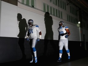 GLENDALE, AZ - SEPTEMBER 15:  Defensive end Jason Jones #91 and defensive tackle Ndamukong Suh #90 of the Detroit Lions walk out to the field before the NFL game against the Arizona Cardinals at the University of Phoenix Stadium on September 15, 2013 in Glendale, Arizona.  (Photo by Christian Petersen/Getty Images)