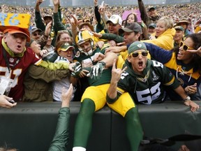 Green Bay Packers' Jordy Nelson celebrates with fans after a touchdown catch during the first half of an NFL football game against the Washington Redskins Sunday, Sept. 15, 2013, in Green Bay, Wis. (AP Photo/Mike Roemer)