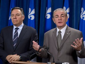 Coalition Avenir Quebec legislature member Jacques Duchesneau, right, responds to reporters questions over what he said about former Parti Quebecois Leader and Environment Minister Andre Boisclair, Thursday, September 26, 2013 at the legislature in Quebec City. CAQ leader Francois Legault, stands by Duchesneau. THE CANADIAN PRESS/Jacques Boissinot