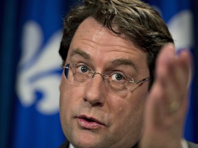 Quebec Democratic Institutions Minister Bernard Drainville today unveiled the details of Quebec's proposed charter of values. While "heritage" symbols such as the crucifix in the National Assembly and Christmas trees will remain in the public sector, "ostentatious" religious symbols worn by public employees would be banned. THE CANADIAN PRESS/Jacques Boissinot ORG XMIT: jqb105