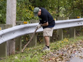 George Panciuk helps to clean up l'Anse a l'Orme Park by the road.