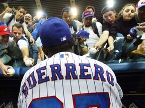 Montreal Expos right fielder Vladimir Guerrero signs autographs before the team's final home game of the season against the Atlanta Braves in Montreal Wednesday, Sept. 17, 2003. The Toronto Blue Jays will play a pair of pre-season games next spring at Montreal's Olympic Stadium. The Blue Jays will host the Mets on March 28-29 in the first Major League Baseball games to be played at the stadium in 10 years. THE CANADIAN PRESS/Ryan Remiorz