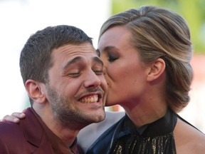 Actress Evelyne Brochu, right, kisses director Xavier Dolan as they arrive for the screening of the movie 'Tom at the Farm' at the 70th edition of the Venice Film Festival Monday, Sept. 2, 2013. (AP Photo/Andrew Medichini)