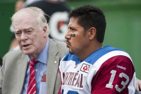 Concussed Als quarterback Anthony Calvillo sits on team bench with Dr. David Mulder during August game at Saskatchewan.
Liam Richards/Canadian Press