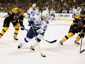 BOSTON, MA - OCTOBER 3: Martin St. Louis #26 of the Tampa Bay Lightning carries the puck in the offensive zone against the Boston Bruins in the second period during the home opener game on October 3, 2013 at TD Garden in Boston, Massachusetts. (Photo by Jared Wickerham/Getty Images)