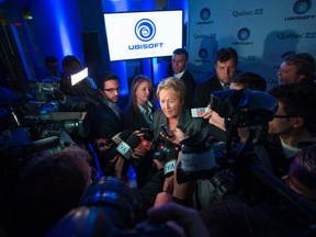 Quebec Premier Pauline Marois speaks with reporters after a press conference to announce Ubisoft's $375 million expansion project at the new company studio in downtown Montreal on Monday, September 30, 2013.