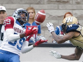 Montreal Alouettes player Duron Carter, left, catches a pass for a touchdown as he is chased by Winnipeg Blue Bombers player Johnny Sears, right, during the first half of their CFL football match in Montreal on Monday, October 14, 2013.