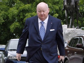 Sen. Mike Duffy makes his way to the Senate on Parliament Hill in this file photo from  May 28, 2013. The RCMP is alleging today that Duffy awarded
$65,000 in contracts to a friend who did little tangible work - the latest wrinkle in the case against the former Conservative. THE CANADIAN PRESS/Fred Chartrand