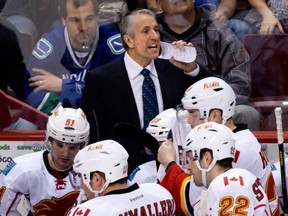 Calgary Flames' head coach Bob Hartley calls out from behind the bench during the third period of an NHL hockey game against the Vancouver Canucks in Vancouver, B.C., on Saturday April 6, 2013. THE CANADIAN PRESS/Darryl Dyck