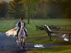 With the sky clearing as the sun sets after a wet Monday, Arianne France rides her 
horse, Callie at Hodgeson Stables in St Lazare Monday, October 7, 2013. 
(Peter McCabe / THE GAZETTE)