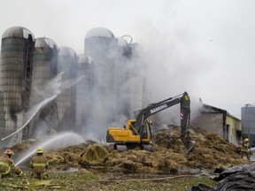 Firefighters fight a blaze that broke out in a large barn at the McGill University's Macdonald Campus on Thursday, Octo, 31, 2013.
