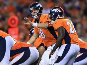 DENVER, CO - SEPTEMBER 23:  Peyton Manning #18 of the Denver Broncos runs the offense against the Oakland Raiders at Sports Authority Field at Mile High on September 23, 2013 in Denver, Colorado.  (Photo by Doug Pensinger/Getty Images)