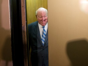 Sen. Mike Duffy takes the elevator as he arrives to the Senate on Parliament Hill in Ottawa on Monday, October 28, 2013. Duffy's allegations this week have provided Prime Minister Stephen Harper with a Halloween filled with a little more chills than usual. THE CANADIAN PRESS/Sean Kilpatrick