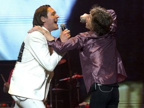 Two marketing masters, Win Butler and Mick Jagger, at the Bell Centre on June 9, 2013. (Justin Tang / THE GAZETTE)