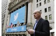 A man uses a mobile phone as he walks past the New York Stock Exchange prior to the Twitter IPO, Thursday, Nov. 7, 2013 in New York.