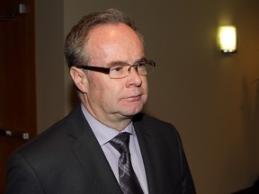 Dr. Gilles Bourdon walks past cameras at his disciplinary hearing in front of the College des medecins du Quebec on April 17, 2013.