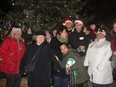 Gathering around the magnificent Christmas Tree teeming with handmade decorations produced by the children of our community.