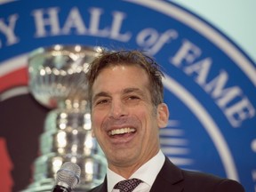 Hockey Hall of Fame inductee Chris Chelios smiles after being presented with his ring at the Hall in Toronto on Friday November 8, 2013. THE CANADIAN PRESS/Frank Gunn