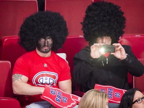 A Montreal Canadiens fan wearing blackface and an afro wig watches the warmup session of the  NHL hockey match between the Montreal Canadiens and the New York Islanders in Montreal on Sunday, November 10, 2013. (Dario Ayala / THE GAZETTE)