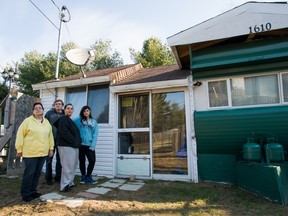 Allan Bassenden, 60, his wife Joni Malley, 57, left; their daughter Natalie Gagnon, 36, and her daughter Bianca Gagnon, 15, stand outside their home in St Lazare on Saturday, November 16, 2013.