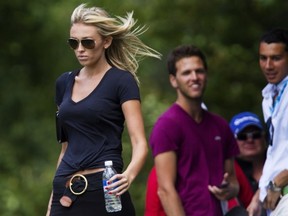 Paulina Gretzky follows her boyfriend Dustin Johnson during the final round of the 2013 RBC Canadian Open at Glen Abbey Golf Club in Oakville, Ont., Sunday, July 28, 2013. THE CANADIAN PRESS/Aaron Lynett
