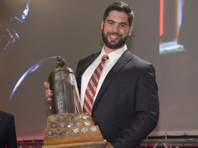 Laurent Duvernay-Tardif, of the McGill University Redmen, receives the J.P. Metras Trophy as the Outstanding Down Lineman during Vanier Cup celebrations Thursday, November 21, 2013 in Quebec City. THE CANADIAN PRESS/Jacques Boissinot