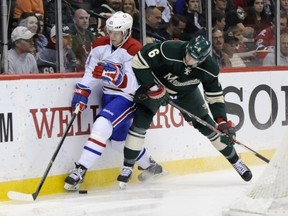 ST PAUL, MN - NOVEMBER 1: Marco Scandella #6 of the Minnesota Wild pins Lars Eller #81 of the Montreal Canadiens to the boards during the second period of the game on November 1, 2013 at Xcel Energy Center in St Paul, Minnesota. (Photo by Hannah Foslien/Getty Images)