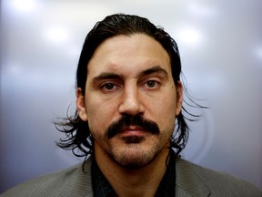 Montreal Canadiens George Parros displays his grown in moustache after having shaved it in support for the Movember campaign in Montreal on Tuesday December 3, 2013.