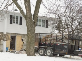 Construction crews work early Sunday morning, Dec.1, at a home in Dollard after a car driven by a 25-year-old woman drove into the home over night.