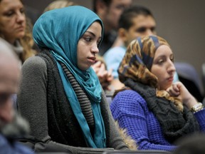 Two women wearing hijabs listen to discussion about Bill 60, Quebec's Charter of Values at Concordia University in Montreal last week. This week, the Universite de Sherbrooke and Universite de Montreal said they opposed the ban on religious symbols contained in the proposed law. (John Mahoney / THE GAZETTE)