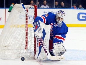 NEW YORK, NY - DECEMBER 15:  Henrik Lundqvist #30 of the New York Rangers defends his net in the firstperiod against the Calgary Flames at Madison Square Garden on December 15, 2013 in New York City.  (Photo by Jim McIsaac/Getty Images)