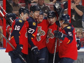 SUNRISE, FL - DECEMBER 3: Jonathan Huberdeau #11 (C) of the Florida Panthers celebrates his first period goal with teammates against the Ottawa Senators at the BB&T Center on December 3, 2013 in Sunrise, Florida. (Photo by Joel Auerbach/Getty Images)