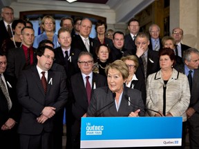 Quebec Premier Pauline Marois, centre, speaks at a news conference marking the end of the fall session last Friday. As she spoke, an online survey was being conducted by the CROP polling firm that suggested public satisfaction with her government is on the rise. THE CANADIAN PRESS/Jacques Boissinot