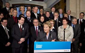 Quebec Premier Pauline Marois, centre, speaks at a news conference marking the end of the fall session last Friday. As she spoke, an online survey was being conducted by the CROP polling firm that suggested public satisfaction with her government is on the rise. THE CANADIAN PRESS/Jacques Boissinot