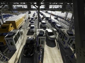 Traffic starts to flow west through a toll booth on Highway 30 in Les Cèdres on December 15, 2012, the first day the highway opened to traffic.