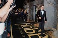 Actor Benedict Cumberbatch sprints down the black-and-gold carpet at the Los Angeles premiere of The Hobbit: The Desolation of Smaug, December 2, 2013 at the TCL Chinese IMAX Theater in Hollywood, California.  (ROBYN BECK/AFP/Getty Images)