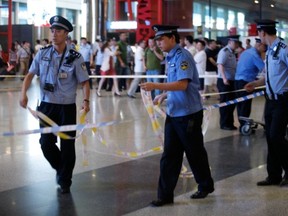 Security personnel secure Terminal 3 of the Beijing Capital International Airport where an explosion occurred on July 20, 2013 in Beijng, China. According to the witness, a man warned people around him to leave before he set off a homemade bomb.