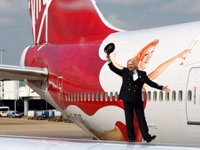 Virgin Atlantic boss Richard Branson walks on the wing of a jumbo jet at Heathrow Airport in 2009.