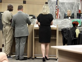 Former Miami Dolphins and NFL football star Chad Johnson, left, appears in court before Judge Kathleen McHugh, facing camera right, in Broward County Circuit Court, Monday, June 17, 2013, in Fort Lauderdale, Fla. Johnson apologized for disrespecting the judge when he slapped his attorney on the backside in court last week, and his immediate release from jail was ordered. (AP Photo/Cristobal Herrera, Pool)