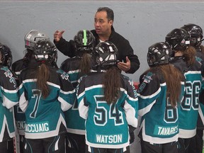 Pointe-Claire ringette coach Jerdy Eastmond speaks to his players behind the bench on Monday.