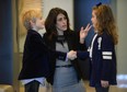 Ana Tajuelo teaches 7-year-old Audra and 6-year-old Johnathan Xinos how to properly shake hands. (Graham Hughes/THE GAZETTE)