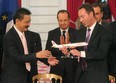 Airbus CEO Fabrice Bregier, right, hands over an Airbus 320 model to CEO of Lion Air, Indonesian Rusdi Kirana, left, last March at a ceremony at the Elysee palace while France's President Francois Hollande looks on.
Lion Air is to buy 234 short to medium range aircraft from Airbus for 18.4 billion Euro ($24 billion), in what is being billed as the biggest civilian deal in the history of the aircraft manufacturer.