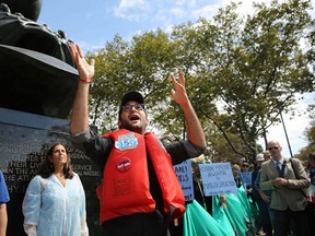 NEW YORK, NY - SEPTEMBER 21: Josh Fox, the director of "Gasland" I and II speaks as hundreds of anti-fracking and Keystone XL pipeline activists demonstrate in lower Manhattan on September 21, 2013 in New York City. Across the country numerous protests are planned on what activists are calling a national day of action to "Draw the Line" on tar sands, Keystone XL, and fracking which many people believe are contributing to climate change and other environmental issues affecting communities. The controversial Keystone XL pipeline project looks to get U.S. permission to funnel Canada's carbon-heavy oil sands across the United States to refineries on the Texas and Louisiana Gulf Coasts. (Photo by Spencer Platt/Getty Images)