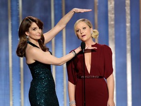Tina Fey and Amy Poehler are back as hosts of the 71st annual Golden Globe Awards Sunday, Jan. 12, 2014. AP Photo/NBC, Paul Drinkwater