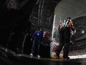 Referee Dave Jackson #8 walks out to work the game between the New Jersey Devils and the Columbus Blue Jackets on Dec.27, 2013, in Newark, New Jersey.