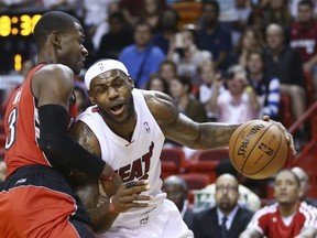 Miami Heat's LeBron James (6) drives around Toronto Raptors' Terrence Ross (31) during the first half of an NBA basketball game, Sunday, Jan. 5, 2013, in Miami. (AP Photo/J Pat Carter)