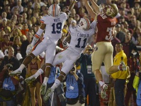 Auburn's Ryan White (19) and Chris Davis (11) break up a pass intended for Florida State's Nick O'Leary (35) during the first half of the NCAA BCS National Championship college football game Monday, Jan. 6, 2014, in Pasadena, Calif. (AP Photo/Mark J. Terrill)