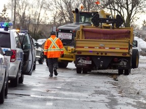 Police and city vehicles remain at the site where a pedestrian was involved in an incident with a snow clearing crew on Pierrefonds Blvd. on Monday, Jan. 6.