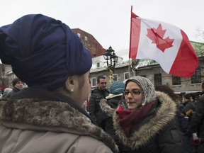People wear religious head wear during a gathering in Montreal, Sunday, January 12, 2014, to oppose the proposed Quebec Values Charter. If implemented, the law would ban the wearing of religious symbols and clothing in all public institutions. A survey on the charter conducted for The Gazette suggests tensions are rising over the proposed legislation. THE CANADIAN PRESS/Graham Hughes