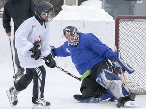 Two participants battle it out during an on ice skills competition.